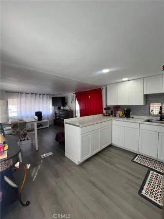 a kitchen with a refrigerator and a stove top oven