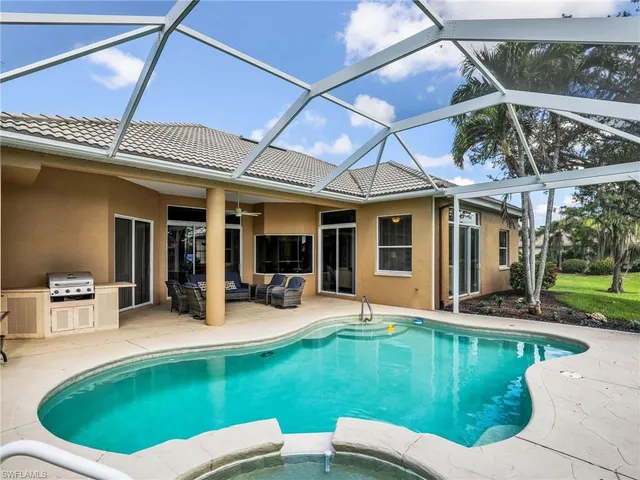 a view of a house with swimming pool and sitting area