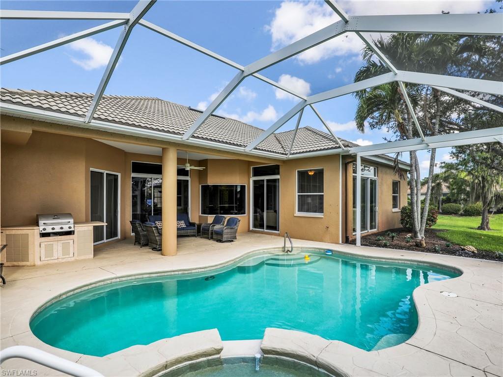 8845 Lely Island Circle Naples, FL 34113 - Photo 11 of 45 a view of a house with swimming pool and sitting area