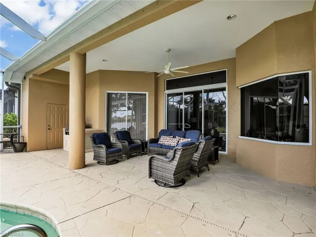 a living room with furniture large window and furniture