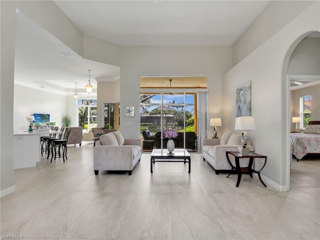 8845 Lely Island Circle Naples, FL 34113 - Photo 14 of 45 a living room with furniture and a large window