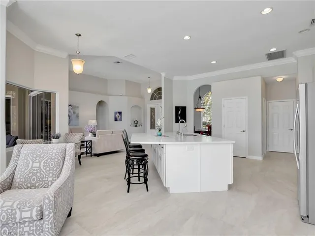 an aerial view of a house with a garden and lake view