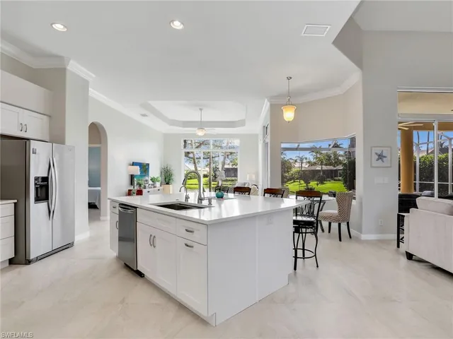 a large kitchen with kitchen island a dining table and chairs