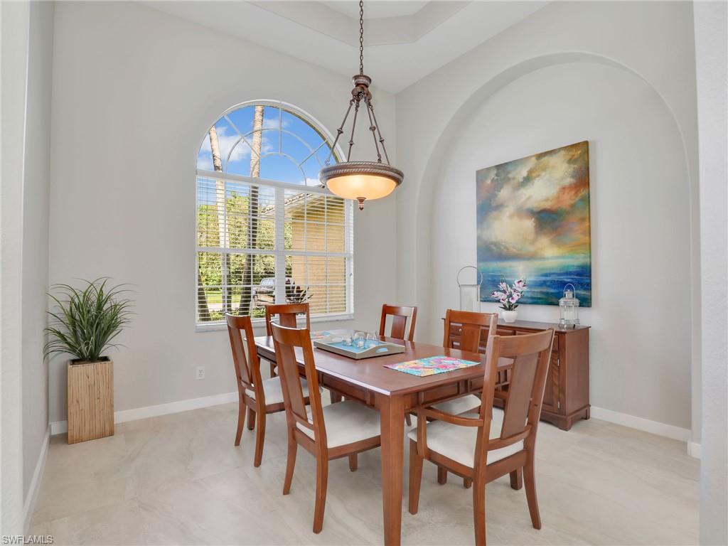 8845 Lely Island Circle Naples, FL 34113 - Photo 20 of 45 a dining room with furniture and window