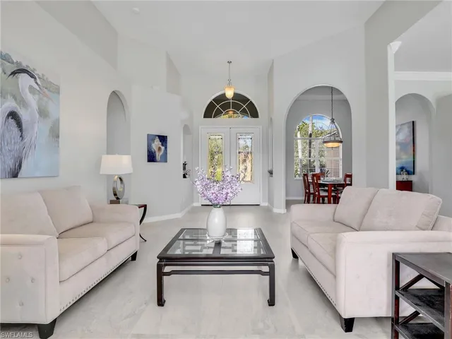 a kitchen with stainless steel appliances kitchen island granite countertop a table and chairs in it