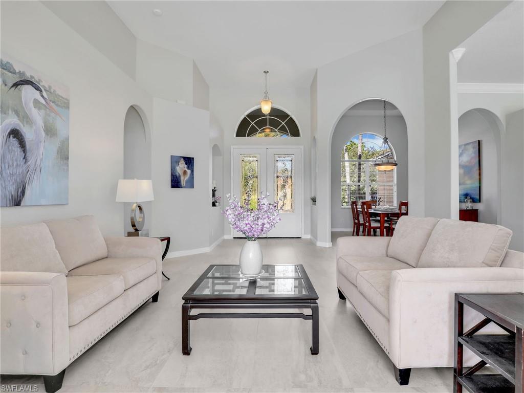 8845 Lely Island Circle Naples, FL 34113 - Photo 21 of 45 a living room with furniture and a large window