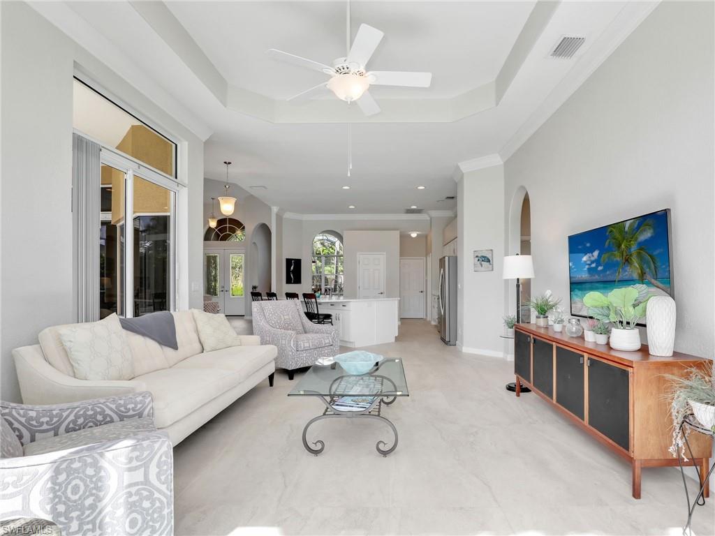 8845 Lely Island Circle Naples, FL 34113 - Photo 22 of 45 a living room with furniture and a flat screen tv