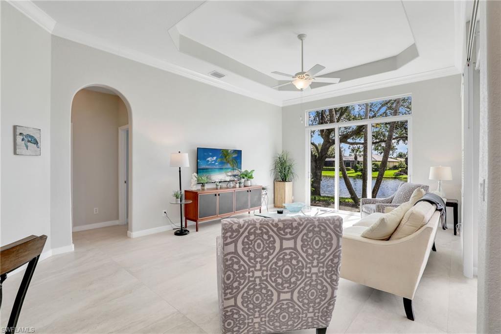 8845 Lely Island Circle Naples, FL 34113 - Photo 23 of 45 a living room with furniture and a flat screen tv