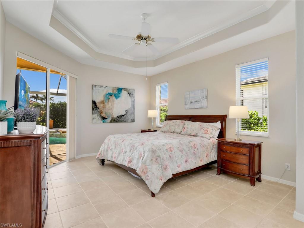 8845 Lely Island Circle Naples, FL 34113 - Photo 27 of 45 a bedroom with a bed and a painting on the wall