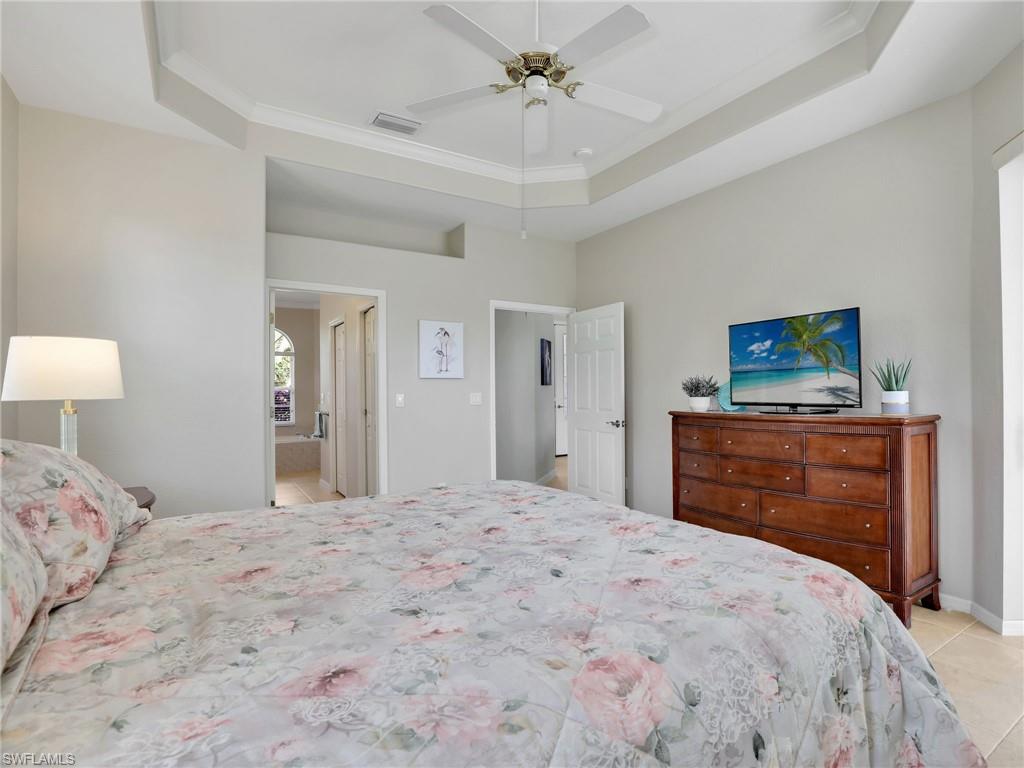 8845 Lely Island Circle Naples, FL 34113 - Photo 28 of 45 a bedroom with a bed and a dresser