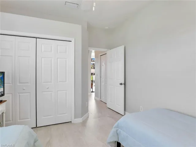 a bedroom with a bed and a painting on the wall