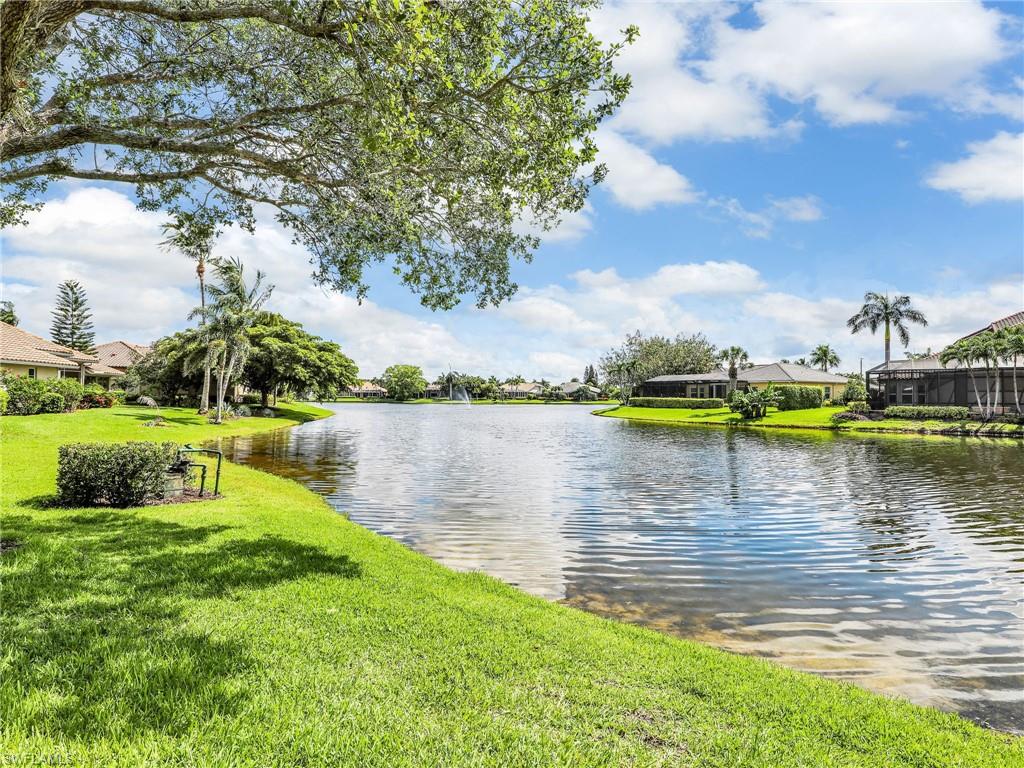 8845 Lely Island Circle Naples, FL 34113 - Photo 36 of 45 a view of a lake with houses in the back