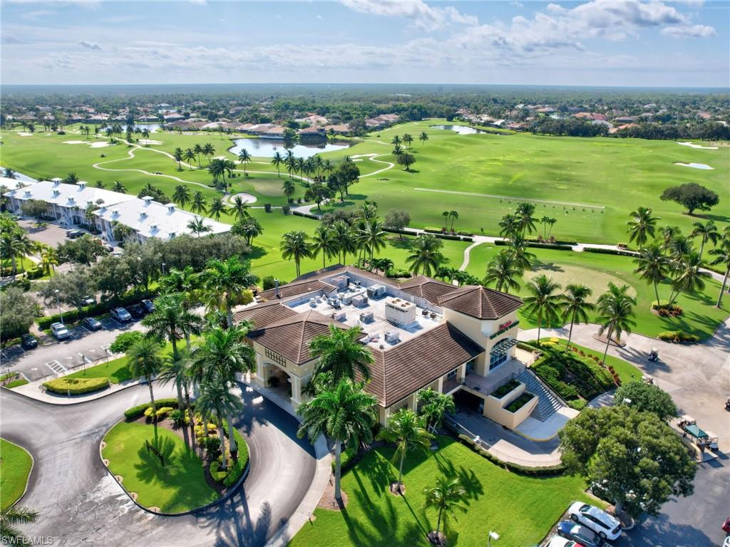 8845 Lely Island Circle Naples, FL 34113 - Photo 37 of 45 a view of a lake with a building in the background