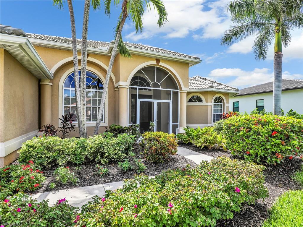 8845 Lely Island Circle Naples, FL 34113 - Photo 4 of 45 front view of the house and a yard