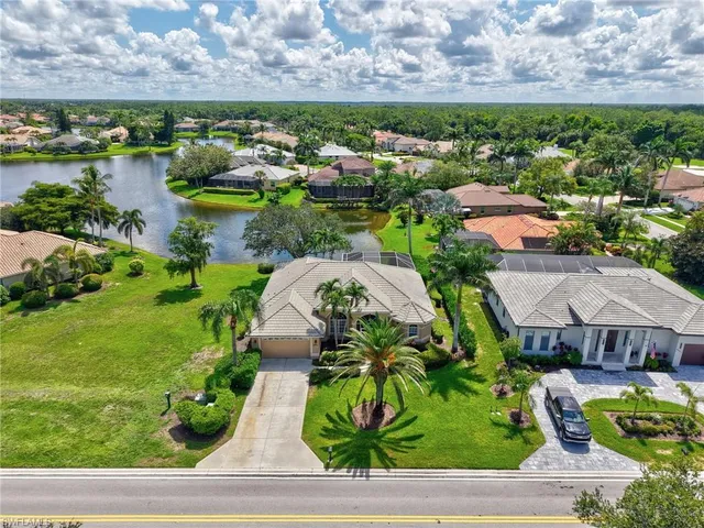 a aerial view of a house with a garden and lake view
