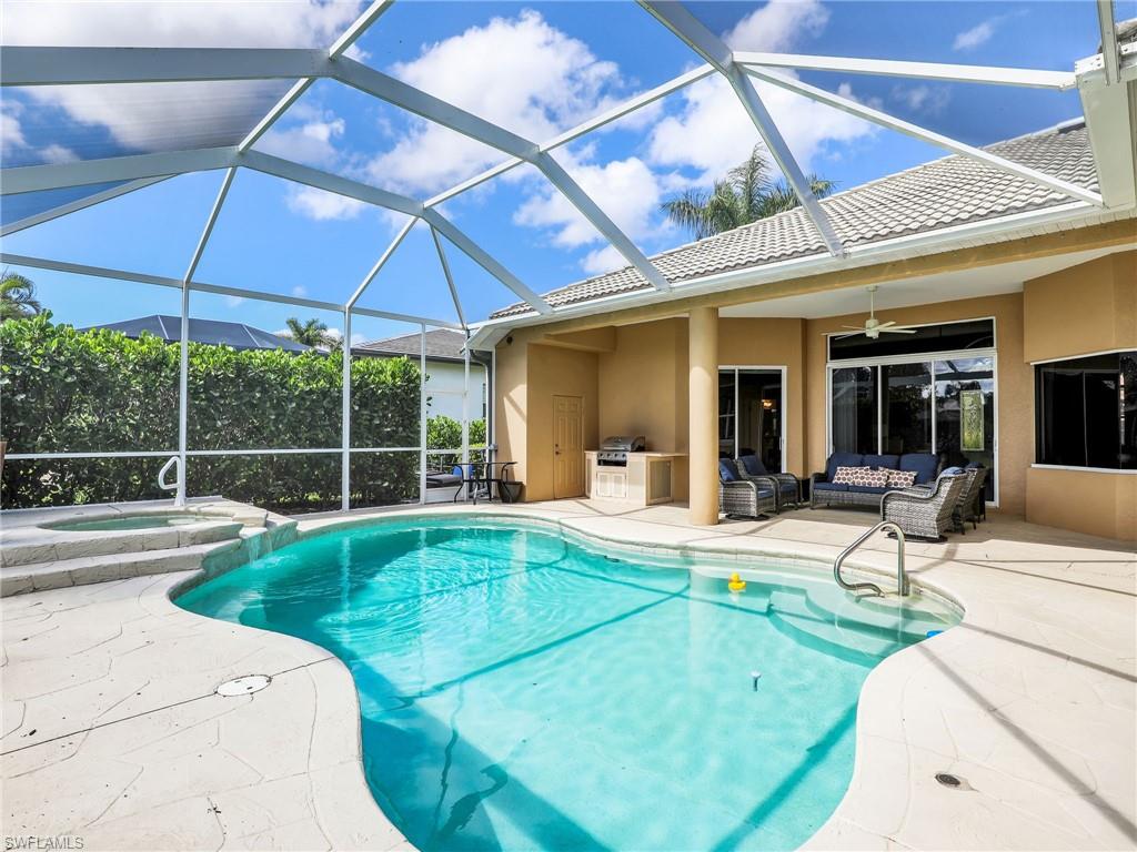 8845 Lely Island Circle Naples, FL 34113 - Photo 8 of 45 a view of a house with backyard sitting area and tub
