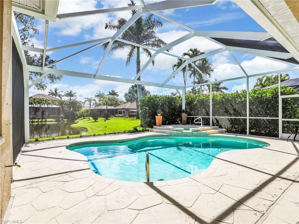 8845 Lely Island Circle Naples, FL 34113 - Photo 9 of 45 a view of a patio with a table and chairs
