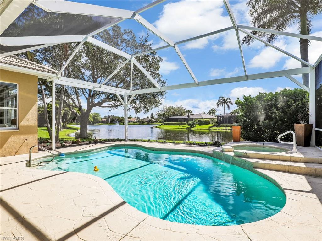 8845 Lely Island Circle Naples, FL 34113 - Photo 10 of 45 a view of a swimming pool with a patio