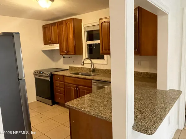 a kitchen with a stove and a refrigerator