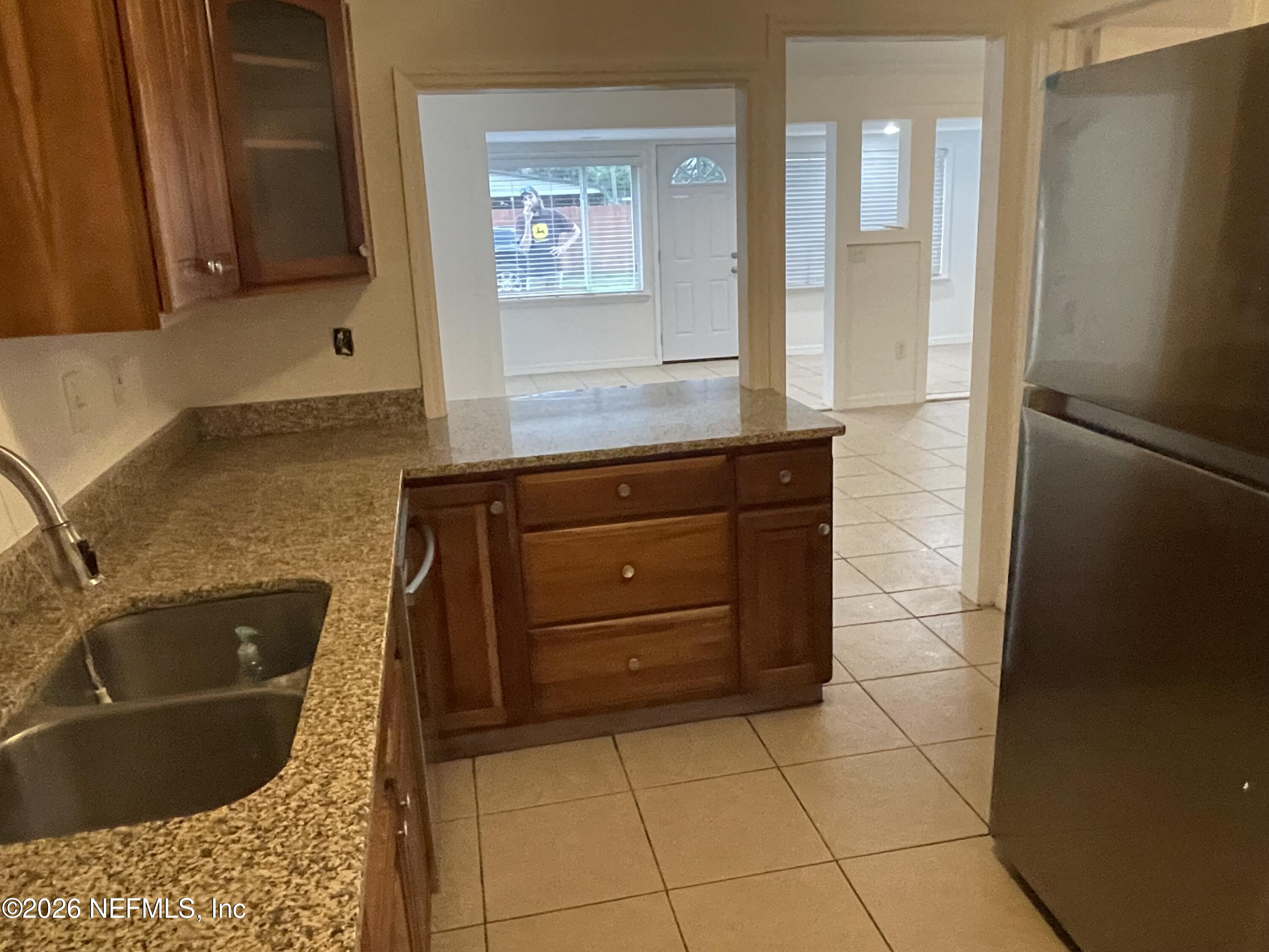 1815 5th Street St. Cloud, FL 34769 - Photo 4 of 9 a bathroom with a bathtub sink and mirror