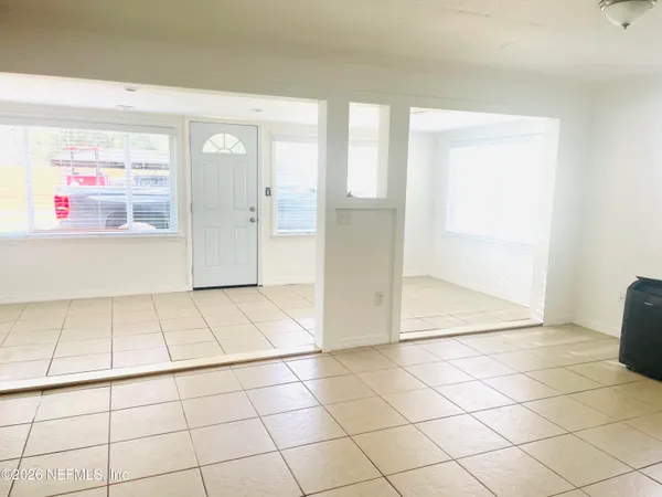 a view of a livingroom with an empty space and a window
