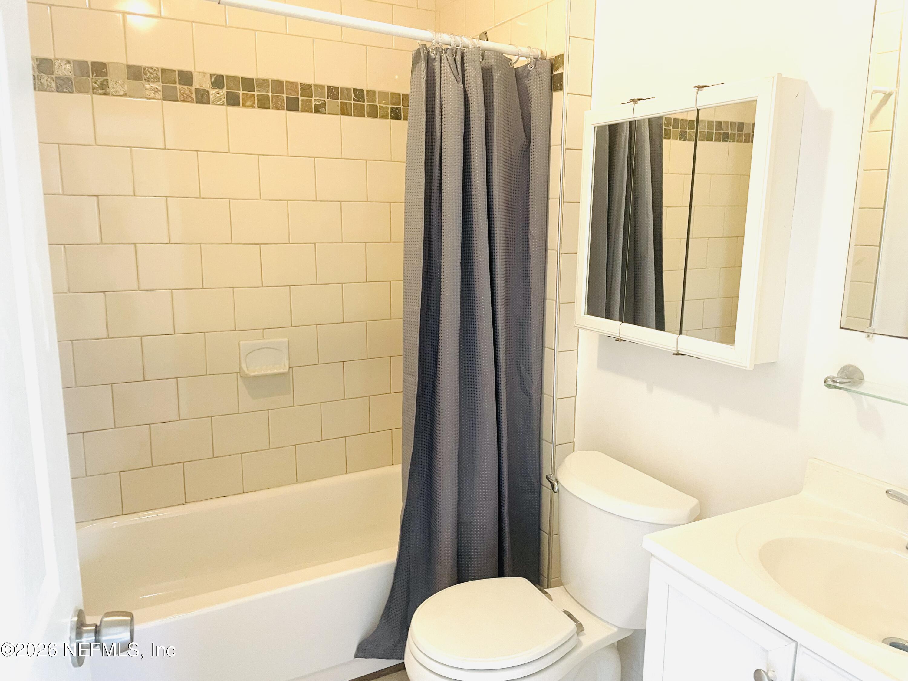 1815 5th Street St. Cloud, FL 34769 - Photo 6 of 9 a bathroom with a toilet and a bathtub