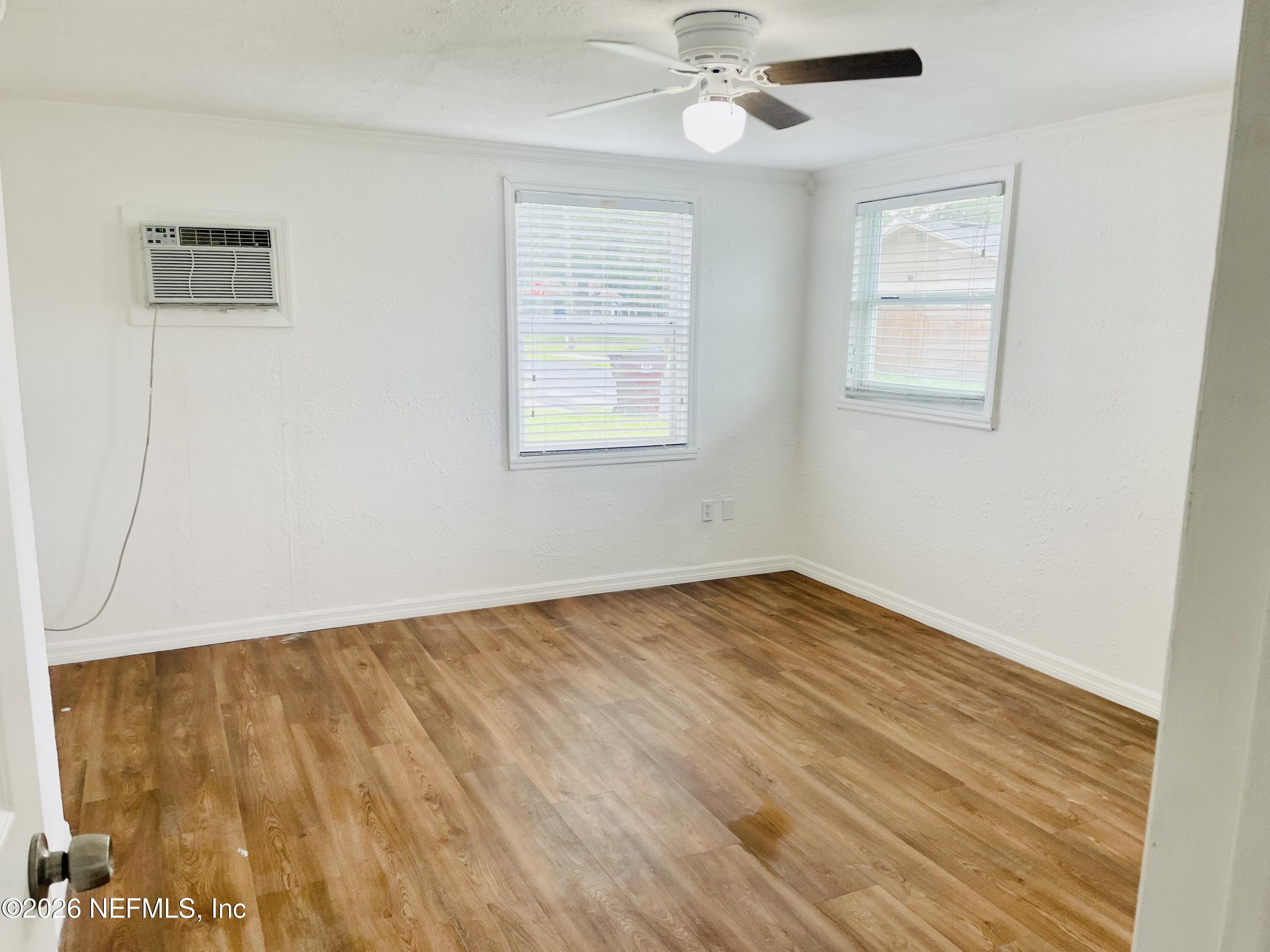 1815 5th Street St. Cloud, FL 34769 - Photo 7 of 9 a view of empty room with wooden floor and fan