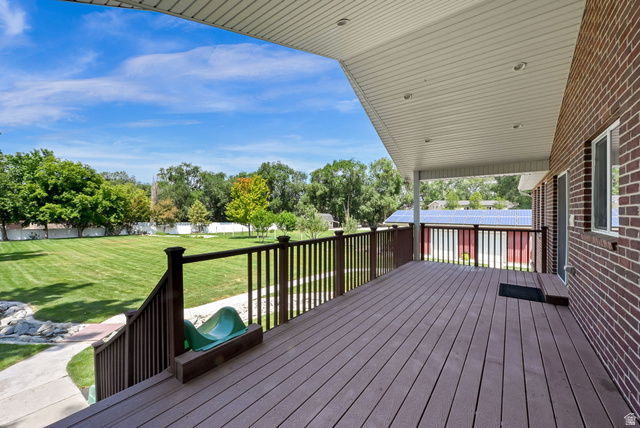 13658 South Fort Street Draper, UT 84020 - Photo 59 of 87 Spacious outdoor deck with composite wood-finish flooring, dark wood railings, and a white soffit ceiling with recessed lighting