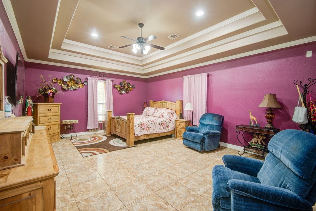 24910 Farm To Market 2004 Angleton, TX 77515 - Photo 19 of 50 a bedroom with furniture and a chandelier
