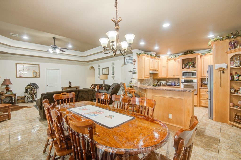 24910 Farm To Market 2004 Angleton, TX 77515 - Photo 9 of 50 a view of a dining room with furniture and a chandelier