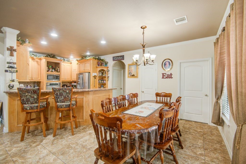 24910 Farm To Market 2004 Angleton, TX 77515 - Photo 10 of 50 a view of a dining room with furniture and chandelier