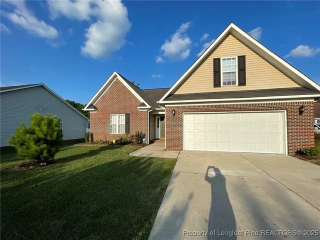 a front view of a house with a yard and garage