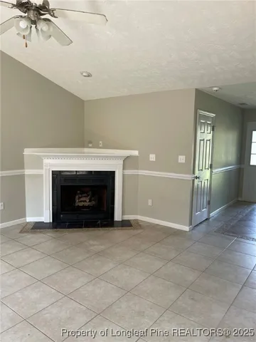 a view of an empty room with a fireplace