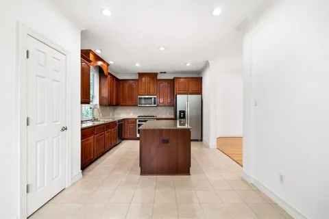 a large kitchen with stainless steel appliances and cabinets