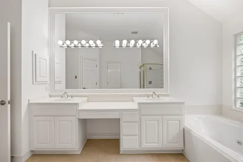a bathroom with a sink double vanity and a mirror