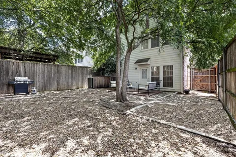 a view of a house with a yard and tree