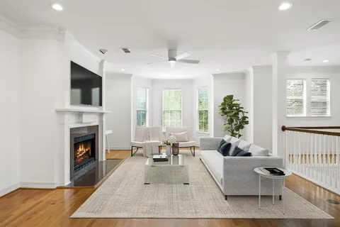 a living room with furniture fireplace and window