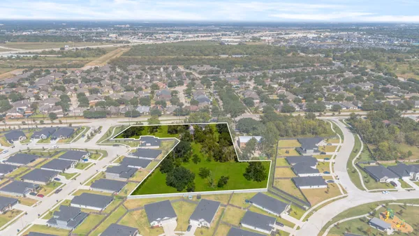 an aerial view of lake and residential houses with outdoor space