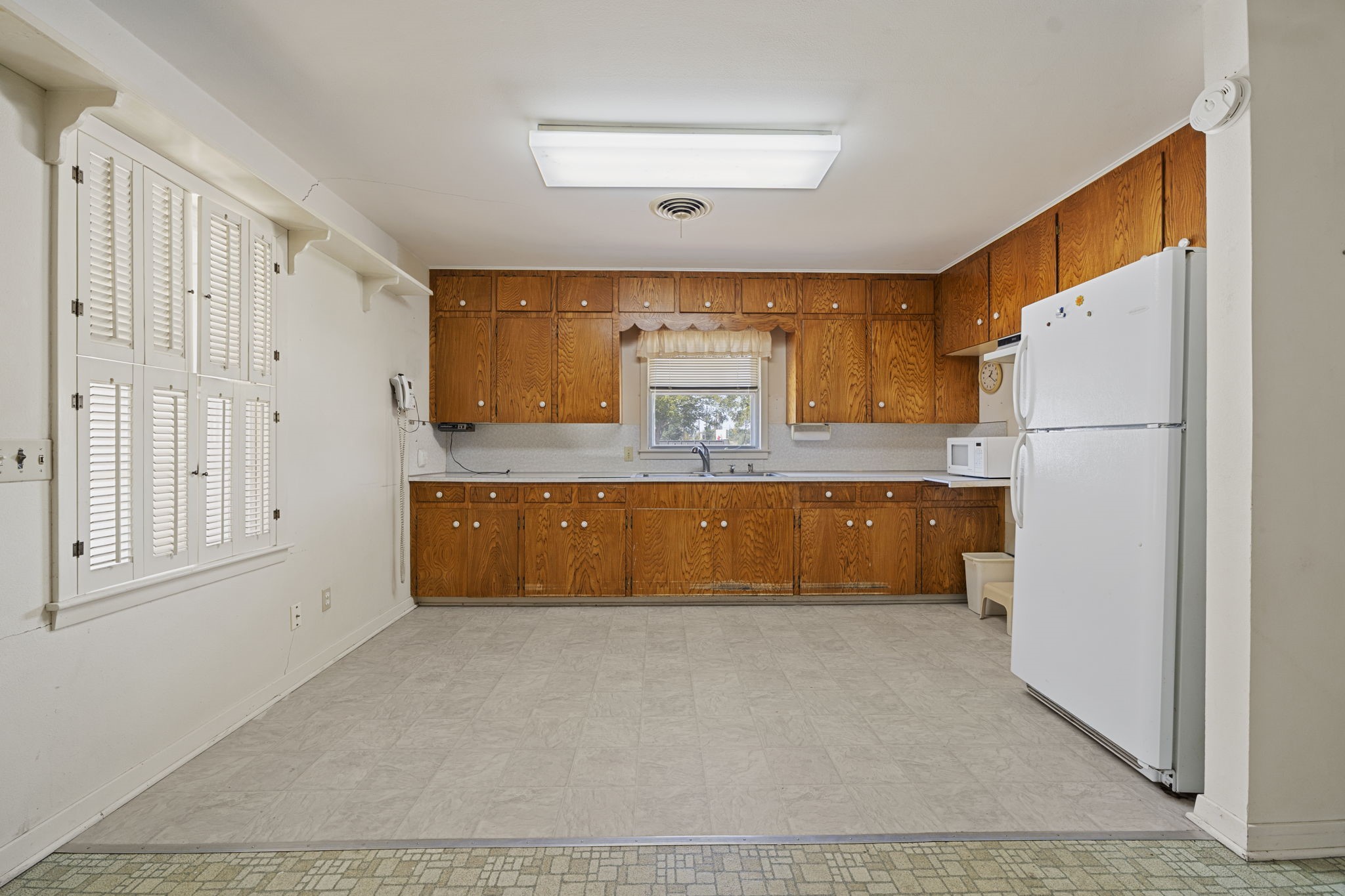 5418 Bryan Road Rosenberg, TX 77469 - Photo 18 of 49 a large kitchen with a refrigerator a stove a microwave and cabinets