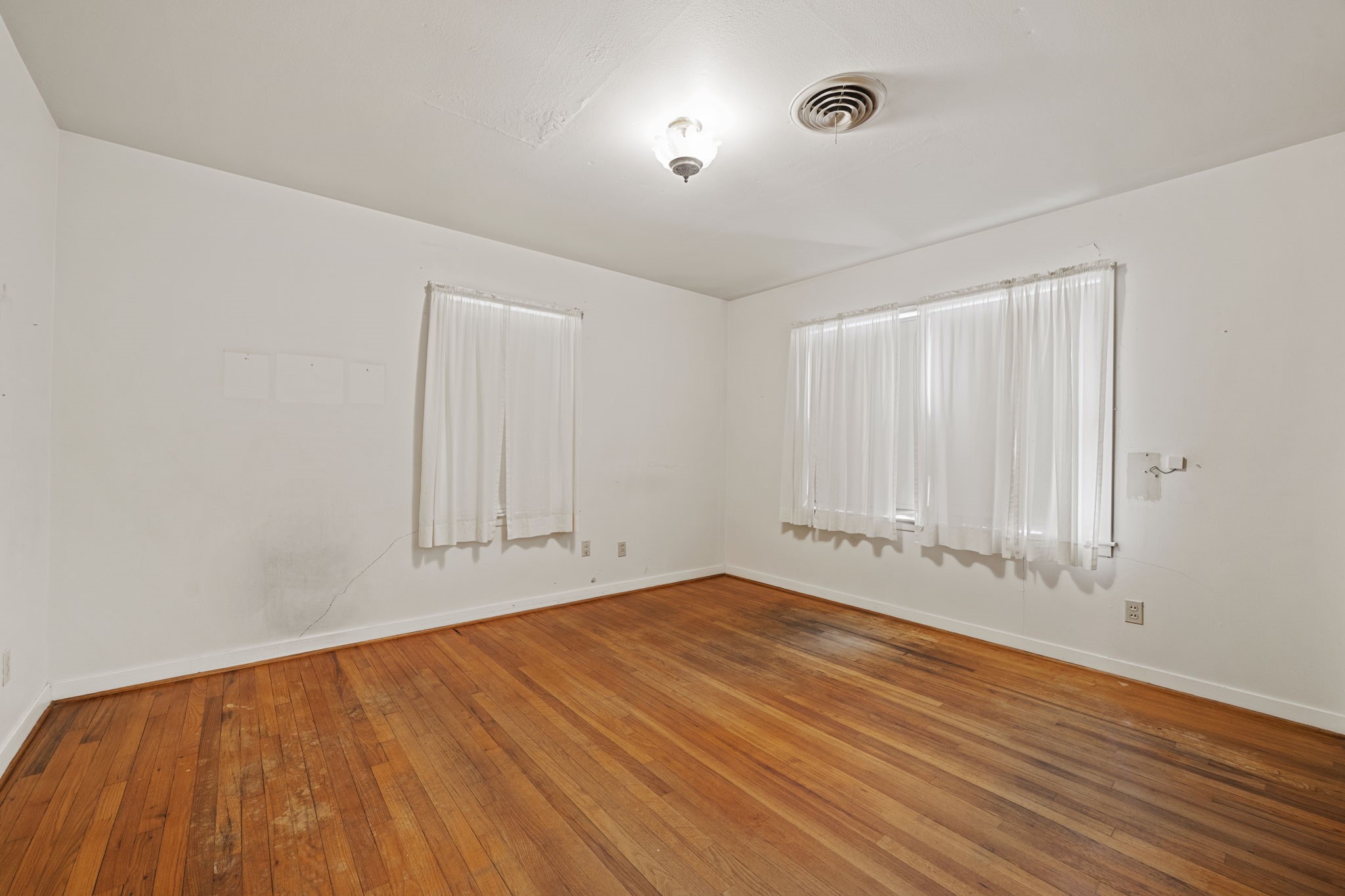 5418 Bryan Road Rosenberg, TX 77469 - Photo 26 of 49 a view of an empty room with wooden floor and a window