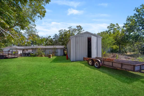 a view of a backyard with garden and plants