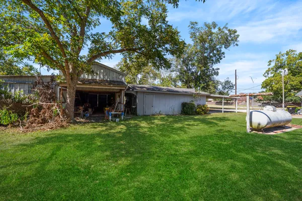 a view of house with backyard
