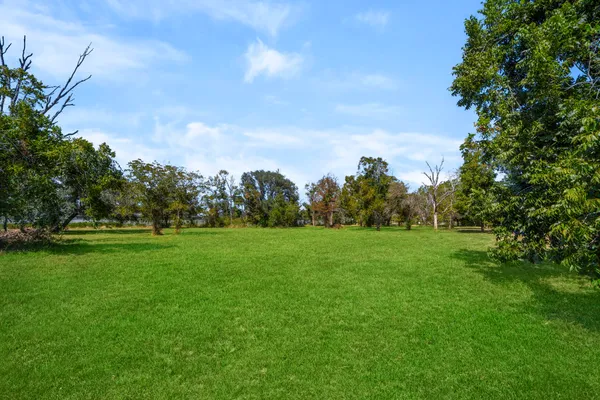 a view of field with trees in the background