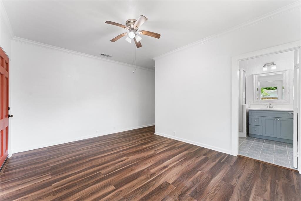 2405 Monroe Street Commerce, TX 75428 - Photo 22 of 31 wooden floor in an empty room with a window