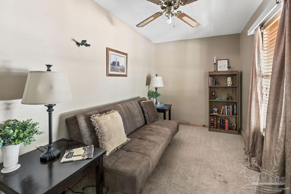 8938 Pioneer Road Holt, FL 32564 - Photo 10 of 44 a living room with furniture and wooden floor