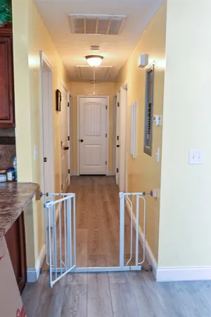 a view of a hallway with wooden floor