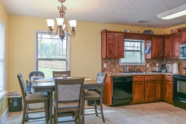 a dining room with a sink a dining table and chairs