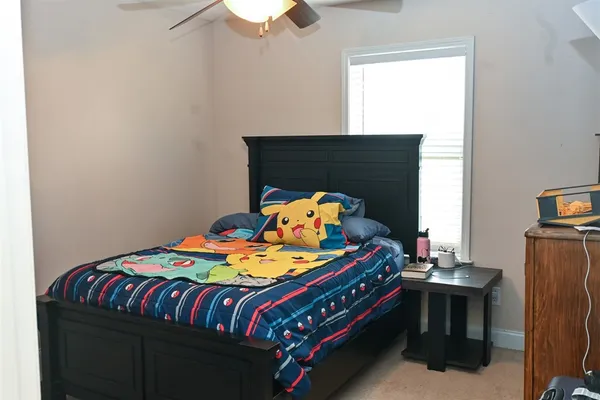 a bedroom with a bed and a dresser in it