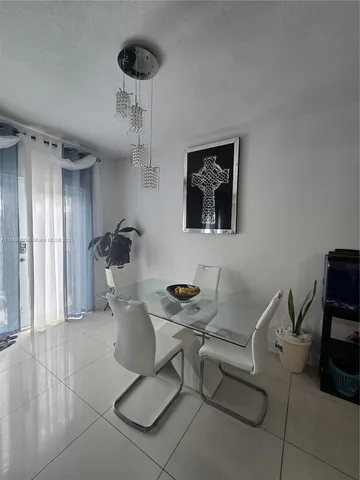 a dining room with furniture and a chandelier