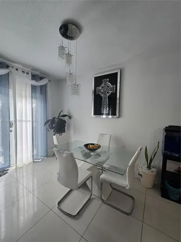 a dining room with furniture and a chandelier